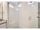 Shower with tile surround, glass door, built-in bench, and chrome fixtures at 1403 Hart Ln, Elizabeth, CO 80107