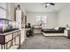 This cozy bedroom features an accent wall, natural light, plush carpet, and space for an office and aquariums at 1403 Hart Ln, Elizabeth, CO 80107