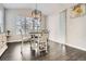 Inviting dining room with a modern light fixture, hardwood floors, and views to the backyard at 1403 Hart Ln, Elizabeth, CO 80107
