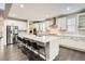 Bright, modern kitchen with white cabinets, stainless steel appliances, and a spacious island with seating at 1403 Hart Ln, Elizabeth, CO 80107