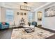 Stylish living room with modern chandelier, neutral walls, and a decorative rug creating an inviting space at 1403 Hart Ln, Elizabeth, CO 80107