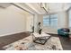 Bright living room with a front door view, featuring a telescope and accent chair at 1403 Hart Ln, Elizabeth, CO 80107