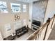 Open-concept living room with soaring ceilings, floor-to-ceiling tile, and comfortable furniture at 1403 Hart Ln, Elizabeth, CO 80107