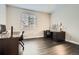 Spacious home office featuring hardwood floors, a large window, and ample workspace for productivity at 1403 Hart Ln, Elizabeth, CO 80107