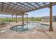 Community pool with pergola, seating, and well-maintained landscaping at 1403 Hart Ln, Elizabeth, CO 80107