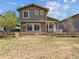 Exterior view of home, showcasing a well-maintained lawn, fenced backyard, and patio space at 10657 Cherrybrook Cir, Highlands Ranch, CO 80126