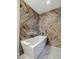 Modern bathroom featuring a freestanding tub and stylish wood-look tiled walls at 10657 Cherrybrook Cir, Highlands Ranch, CO 80126