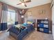 Bright bedroom with a comfortable bed, playful decor, and a ceiling fan at 10657 Cherrybrook Cir, Highlands Ranch, CO 80126