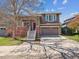 Inviting two-story home showcasing a well-maintained lawn and attached two car garage at 10657 Cherrybrook Cir, Highlands Ranch, CO 80126
