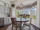 Eat-in kitchen with a view of the backyard, stainless appliances, and custom cabinets at 10657 Cherrybrook Cir, Highlands Ranch, CO 80126