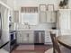 Bright kitchen featuring modern appliances, white cabinets, and elegant countertops at 10657 Cherrybrook Cir, Highlands Ranch, CO 80126