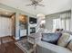 Open living room with a fireplace, TV, staircase, and modern decor at 10657 Cherrybrook Cir, Highlands Ranch, CO 80126
