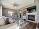 Cozy living room with a fireplace, plush seating, and modern decor at 10657 Cherrybrook Cir, Highlands Ranch, CO 80126