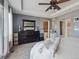 Comfortable main bedroom with tray ceilings, large dresser and access to main bathroom at 10657 Cherrybrook Cir, Highlands Ranch, CO 80126