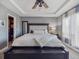 Serene main bedroom with a tray ceiling, large bed, and an abundance of natural light at 10657 Cherrybrook Cir, Highlands Ranch, CO 80126