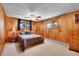 Bedroom with wood paneling, ceiling fan, and a comfortable queen-size bed at 29551 Dorothy Rd, Evergreen, CO 80439