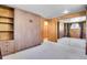 Bedroom with built in shelving and closet, wood paneling, neutral carpet, and natural light at 29551 Dorothy Rd, Evergreen, CO 80439