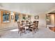 Dining room with six-chair hardwood table, wood-trimmed windows, and neutral walls at 29551 Dorothy Rd, Evergreen, CO 80439