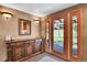 Inviting entryway featuring a wooden door with sidelights and beautiful wood accents at 29551 Dorothy Rd, Evergreen, CO 80439