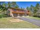 Two-story home features a brick facade, a two-car garage, and a large upper deck with a wood railing at 29551 Dorothy Rd, Evergreen, CO 80439