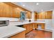 Kitchen with white countertops, wood cabinets, and modern appliances at 29551 Dorothy Rd, Evergreen, CO 80439