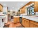 Spacious kitchen featuring wood cabinets, white countertops, and access to other living areas at 29551 Dorothy Rd, Evergreen, CO 80439