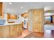 Bright kitchen boasts wood cabinets, and a view of the adjacent living space at 29551 Dorothy Rd, Evergreen, CO 80439
