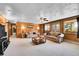 Cozy living room with wood paneling, ceiling fan, and comfortable seating at 29551 Dorothy Rd, Evergreen, CO 80439