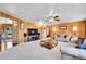 Large living room with wood paneling, neutral carpet, and a view to front yard at 29551 Dorothy Rd, Evergreen, CO 80439