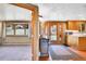 View of the living space featuring a bay window and adjacent kitchen with wood cabinets at 29551 Dorothy Rd, Evergreen, CO 80439