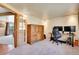 Versatile office space with glass panel doors leading to a sunlit deck area at 29551 Dorothy Rd, Evergreen, CO 80439