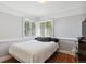 Bright bedroom with hardwood floors, fresh paint, and ample natural light from the large windows, creating a peaceful retreat at 2141 W Gill Pl, Denver, CO 80223