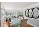 Bright dining room with a modern glass-top table, elegant chairs, decorative mirrors, and ample natural light, ideal for gatherings at 2141 W Gill Pl, Denver, CO 80223