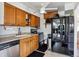 Well-equipped kitchen with stainless steel appliances, wooden cabinets, and functional layout, perfect for cooking and entertaining at 2141 W Gill Pl, Denver, CO 80223