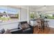 Comfortable living room featuring a cozy armchair, bar with stools, large windows, and ample light for a relaxing space at 2141 W Gill Pl, Denver, CO 80223