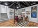 Basement features gray chair, stairs, recessed lights and painted black ceiling at 4032 S Olive St, Denver, CO 80237