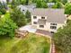 Aerial view of the home and backyard, showcasing the patio, waterfall feature, and lush greenery at 6364 S Walden Ct, Aurora, CO 80016