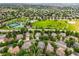 Neighborhood aerial view featuring the surrounding homes, green spaces, tennis courts, and playground at 6364 S Walden Ct, Aurora, CO 80016
