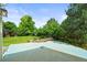 A backyard featuring an extended concrete patio and a beautifully landscaped yard with mature trees at 6364 S Walden Ct, Aurora, CO 80016