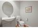 Bathroom with modern fixtures, vanity with gray cabinet and wood-look floors at 6364 S Walden Ct, Aurora, CO 80016