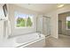 Bright bathroom featuring a separate shower and a large soaking tub with a view at 6364 S Walden Ct, Aurora, CO 80016