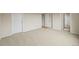 Large empty room with plush carpet. Many doors with access to other rooms at 6364 S Walden Ct, Aurora, CO 80016
