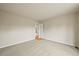 A bedroom with neutral paint, carpeted floors, and a view to the next room through the doorway at 6364 S Walden Ct, Aurora, CO 80016