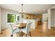 Dining area with wood floors, stylish chandelier, and a sliding door to the yard at 6364 S Walden Ct, Aurora, CO 80016