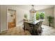 Elegant dining room with modern light fixture, stylish decor, and views of the backyard at 6364 S Walden Ct, Aurora, CO 80016