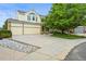 Charming two-story home with a three-car garage, featuring a well-manicured lawn and mature trees at 6364 S Walden Ct, Aurora, CO 80016