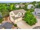 Aerial shot showcasing a two-story home, attached garage, driveway and mature trees at 6364 S Walden Ct, Aurora, CO 80016