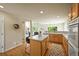 Spacious kitchen featuring wood floors, an island, and ample natural light at 6364 S Walden Ct, Aurora, CO 80016