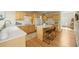 Bright kitchen featuring wood floors, an island, and ample cabinet space at 6364 S Walden Ct, Aurora, CO 80016