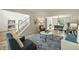 Inviting living room with plush rug, comfortable seating, and an open flow to the dining area at 6364 S Walden Ct, Aurora, CO 80016